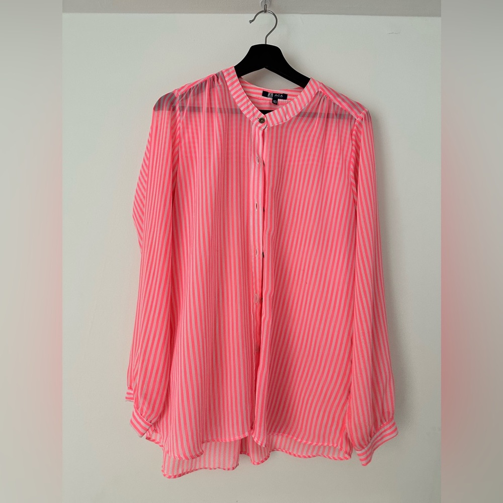 Long sleeve Fuchsia shirt. Is a see through style.